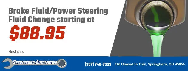 Advertisement for Springboro Automotive featuring a service for brake fluid and power steering fluid change starting at $88.95. Includes an image of green fluid being poured. Contact information and address of the service center are provided.