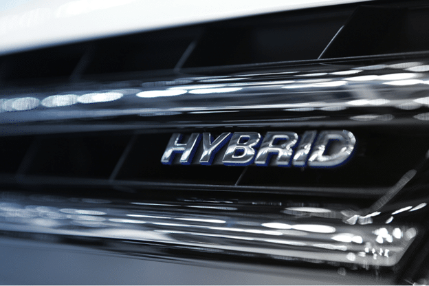 hybrid repair, Auto repair shop in Springboro, OH, Springboro Automotive. Close-up of a hybrid vehicle emblem on a glossy black grille, highlighting modern hybrid technology and eco-friendly automotive innovation.