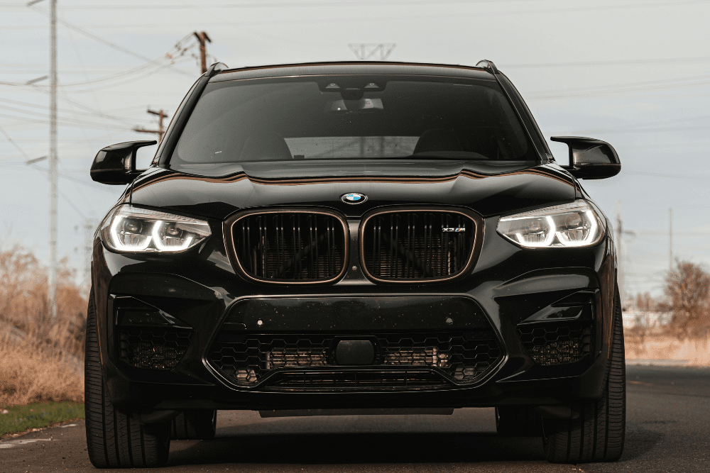 european car maintenance. Auto repair in Springboro, OH. Springboro Automotive. Front view of a black BMW SUV on a road, showcasing the type of luxury vehicle serviced for diagnostics and performance care