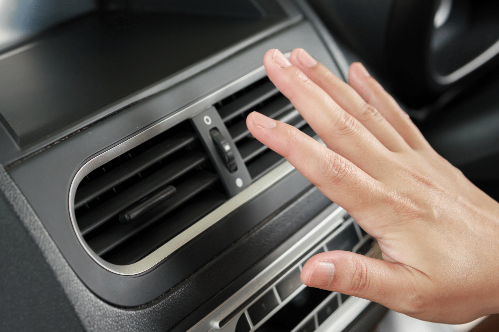 Car A/C Performance Testing in Springboro, OH. Hand checking airflow from a car AC vent during a performance test in Springboro, OH