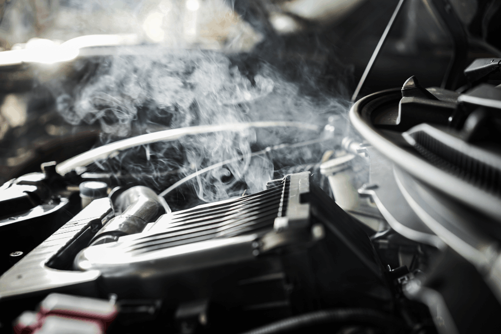 Engine overheating, auto repair in Springboro, OH, at Springboro Automotive. Image of steam rising from an overheating vehicle engine under the hood, highlighting cooling system problems that require prompt diagnosis and repair.